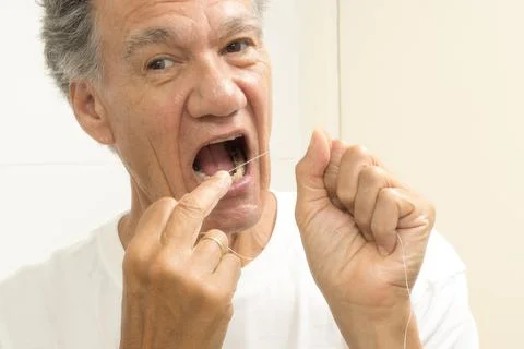 Man flossing his teeth Stock Photos