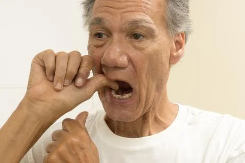 Man flossing his teeth Stock Photos