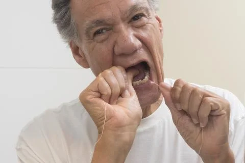 Man flossing his teeth Stock Photos