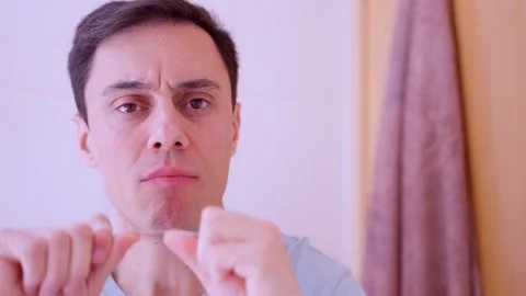 Man flossing teeth and smiling at camera Stock Footage 311305120