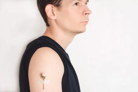 A man with a flower under a patch on his shoulder looks to the side Stock Photos