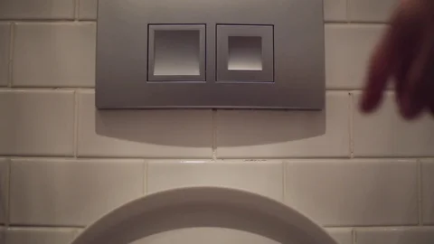 Man flushing the toilet Stock Footage 76480402