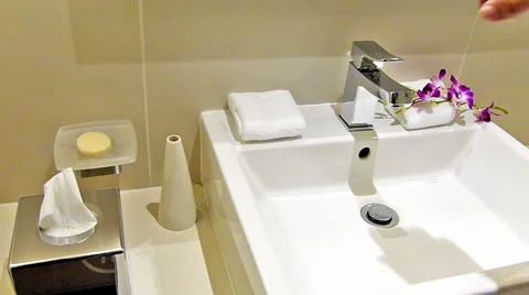 Man flushing water in the sink Stock Footage 46929082