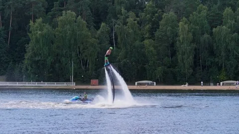 Man on flyboard makes tricks: flip, spin and dive 스톡 동영상 81412864