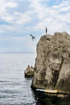 Man flying from the cliff. Stock Photos