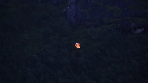 Man flying down in a wing suit and releases parachute in slow motion, Vídeos de archivo 94940549