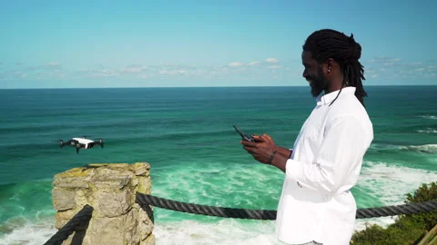 Man flying a drone in front of the sea Stock Footage