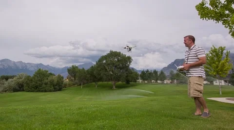 Man Flying Drone Quad Copter in Park Stock Footage 42930588