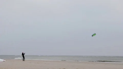 Man flying a kite on beach Stock Footage 71565647