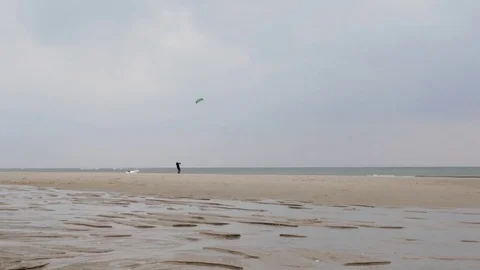 Man flying a kite on beach Stock Footage 71566047