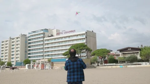 Man flying Kite in winter beach - Slowmotion Stock Footage 117410365