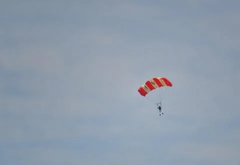 A Man is Flying in the Sky by using IAF Parachute in Airshow for Indian Air.. Foto stock