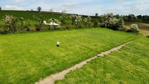 Man flys remote control plane in summer field Stock Footage 108504158