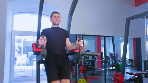 Man focused on training legs on the machine in the gym Stock Footage 73231378