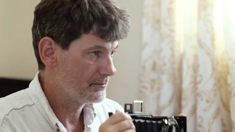 Man focuses old camera Slowmo Stock Footage 77328568
