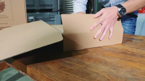 Man folding cardboard box Stock Footage 98286883