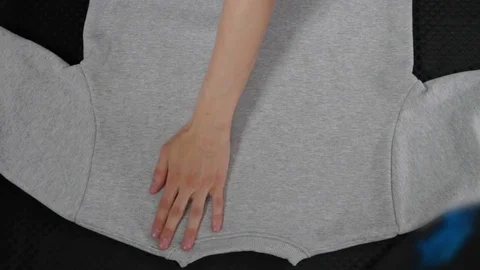 Man folding clothes pullover sweater Stock Footage 73897641