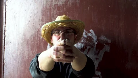 Man folding his hands into the shape of a gun 4K Stock Footage 196727518