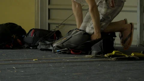 A man folds a backpack with a parachute. Stock Footage 245984843