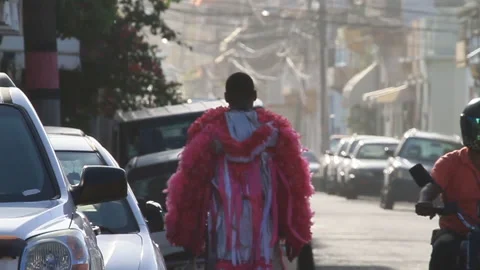 Man in Folk Costume walking down the street in Dominican Republic (slow mo) Stock Footage 185091563
