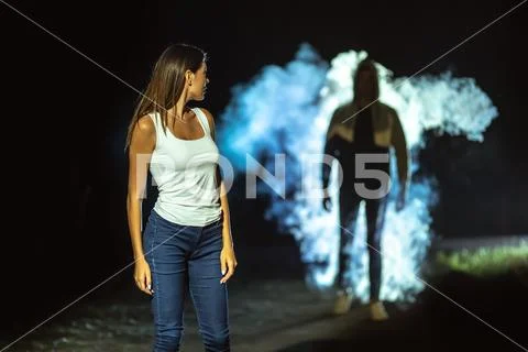 The man following the woman on the dark street Stock Photos