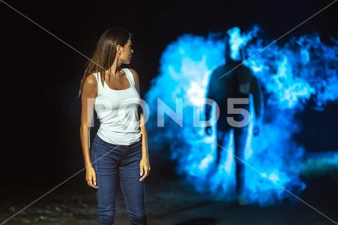 The man following the woman on the dark street Stock Photos