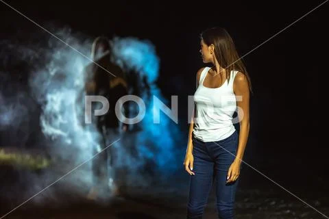 The man following the woman on the dark street Stock Photos