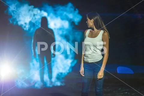 The man following the woman on the dark street Stock Photos