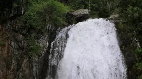 The man at the foot of the waterfall Stock Footage 67605822