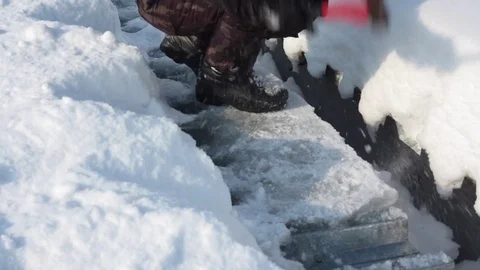 Man forces down the axe an ice cover on a roof Stock Footage 70011517