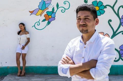 Man in the foreground with girlfriend in the background resting on the colorful Stock Photos