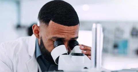 Man, forensic and scientist with microscope for exam, clinic trial or test Foto stock