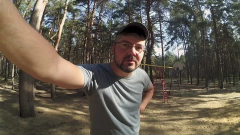A man in the forest records himself on a cam Video stock 196217602