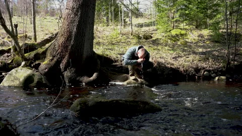 Man by the forest river Stockbeeldmateriaal 130872200