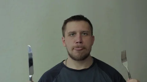 Man with fork and knife waiting dinner. Video stock 77413485