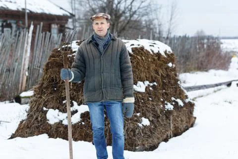 Man with fork in  heap of manure Stock Photos