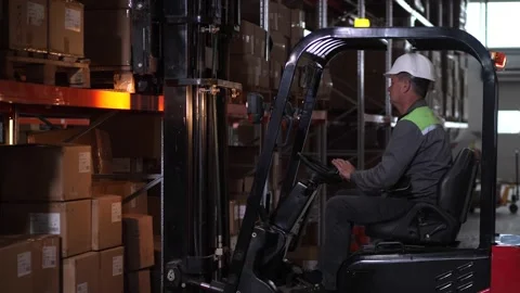 Man forklift operator working in factory storage Video stock 161956128