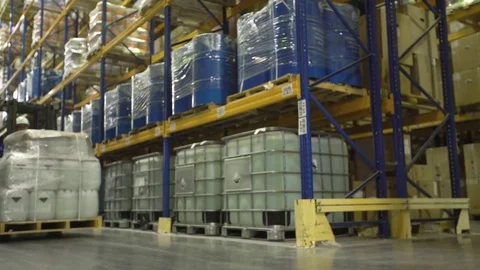 Man on forklift transporting cargo in warehouse Stock Footage 76002271