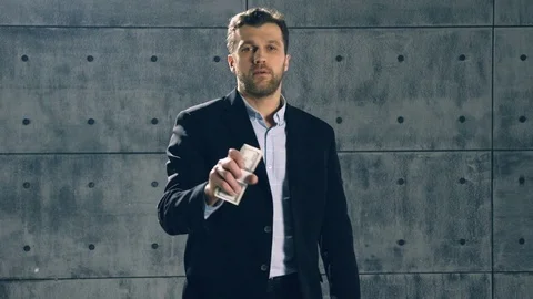 Man in formal suit catches bundle of dollars Video stock 83387307