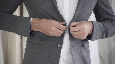 Man in formal suit getting dressed in dressing room for work or wedding. Stock Footage 115959432