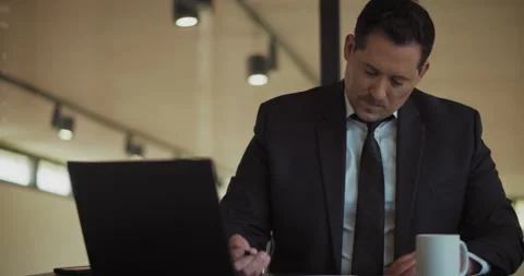 A man in a formal suit working at the office, signing documents. Stock Footage 140203607