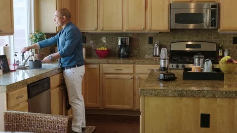 Man in formals filling water in the pot in kitchen Stock Footage 83188053