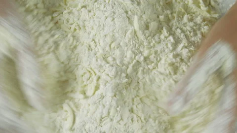 A man forms the dough on a flour-sprinkled surface and kneads it with his hands Stock Footage 136477860