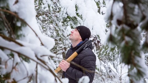 The man found a Christmas tree covered with snow Stock Footage 84693261
