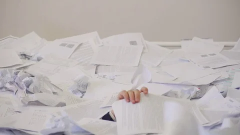 The man found an important document in the bunch of unnecessary documents. Stock Footage 84120527