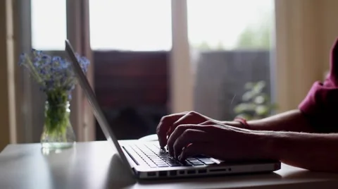 Man freelance designer working on laptop from home table writing message Stock Footage 65016474