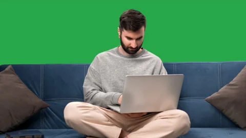 Man freelancer business programmer working use laptop on couch isolated green Stock Footage 230846729