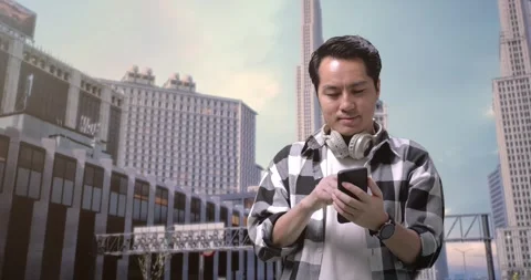 Man Freelancer With Headphones Using Smartphone While Standing In Front Stock Footage 245288459