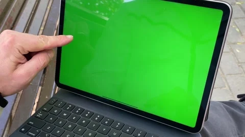 Man freelancer holding black tablet pc with mock up green Stock Footage 243011563
