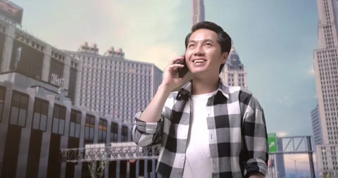 Man Freelancer Talking On Smartphone And Looking Around While Standing In Front Stock Footage 245288060
